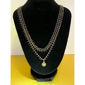 Catherine Popesco Gold decorative layered necklace with crystal and gold charm